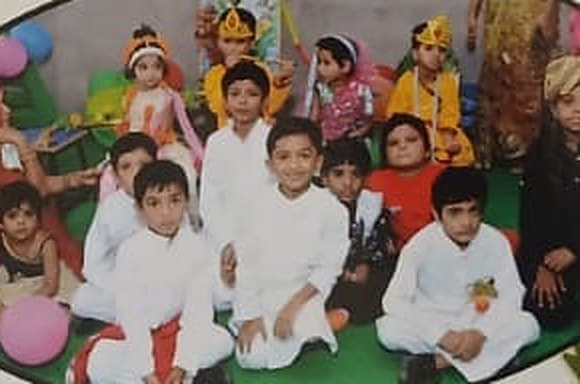 Children in festive costumes seated together for a celebration.