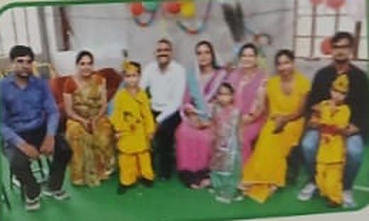 Parents and children in festive dress seated together at a school celebration.