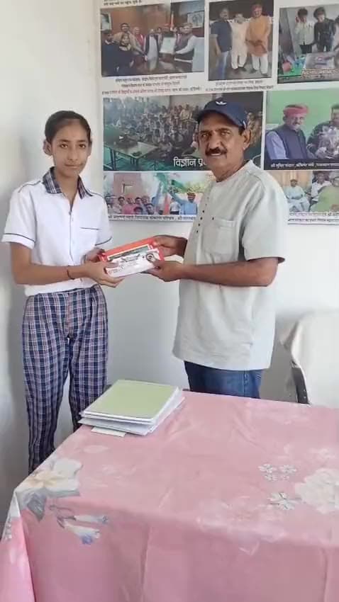 students come forward one by one to receive prizes.